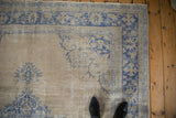 The worn texture and low pile of the corner spandrel on a vintage Oushak carpet.