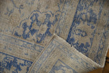 The hand-knotted construction and secured edge of a vintage distressed Oushak rug corner.