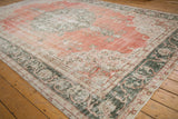 Distressed vintage Sparta carpet texture with dusty terra cotta, green, and ivory floral motifs.