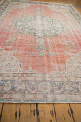 Secured end fringe of the distressed vintage Sparta rug, showing dusty hunter green border.