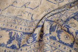 Textured vintage distressed Oushak rug in beige and cobalt blue, highlighting even wear.