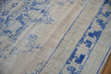 Distressed vintage Oushak carpet pile showing cobalt blue vinery on ivory.