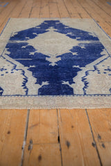 Distressed cobalt blue central design and textured abrashed field of vintage Oushak rug.