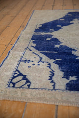 Distressed Oushak rug with bold cobalt blue abrash design and visible wear to foundation.
