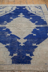 Distressed cobalt blue and ivory geometric Oushak rug texture with low pile.