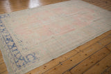 Worn rose pink field and bold cobalt blue border of the Vintage Distressed Oushak.