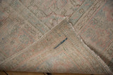 Distressed Oushak rug pile showing wear and subtle colors, with blue painted mark on reverse.