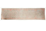 Vintage distressed Oushak runner featuring pale pink, ivory, and seafoam green Rococo medallions, 3'1