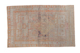 Vintage distressed Sivas rug, central diamond medallion, soft ivory and pale terra cotta tones.