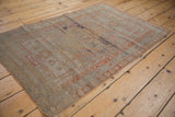 Distressed vintage Sivas rug detail: worn pile texture with faded palmette and cartouche motifs.