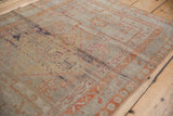 Distressed Sivas rug close-up: worn pile texture, faded ivory, gold, and terracotta motifs.