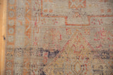 Close-up of vintage Sivas rug showcasing mostly even wear, exposed foundation, and faded ivory, terra cotta, saffron hues.