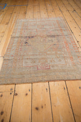 Distressed vintage Sivas rug end, with worn pile and short, secured fringe.