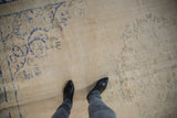 Distressed ivory Oushak carpet pile with faded cobalt blue and slate green patterns.