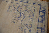 Distressed vintage Oushak carpet texture, showing abrashed ivory, beige, and cobalt blue.