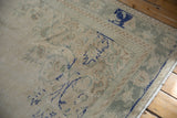 Distressed ivory and slate blue vintage Oushak rug with soft green border and fringe.