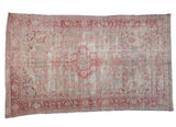 Distressed vintage Oushak carpet, faded cherry red medallion on silver ivory field.