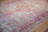 Vintage distressed Oushak rug with low pile and pale cherry red floral motifs on silver.