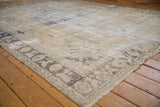Vintage distressed Oushak rug border with beige, oxidized silver palmettes and fringe.