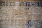 Distressed vintage Oushak rug detail showing faded beige, cobalt blue, oxidized silver florals.