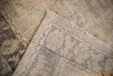 Distressed vintage Oushak rug showing worn pile, exposed foundation, and hand-knotted construction.