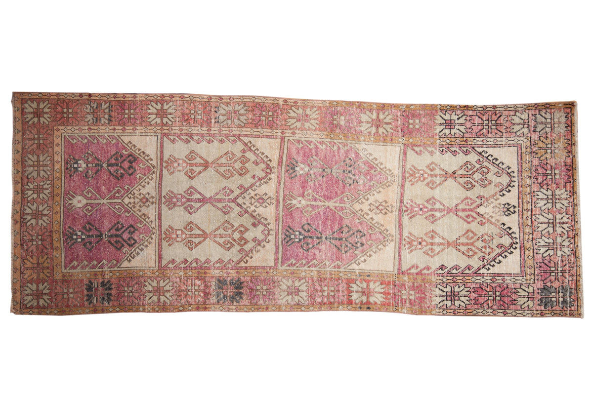 Vintage distressed Oushak runner with stacked geometric panels in faded aubergine, ivory, and charcoal.