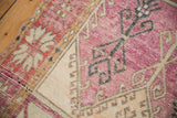 Close-up of serrated palmette border and hook latch motifs in aubergine, saffron, and charcoal.