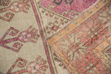 View of the hand-knotted foundation and secured edge on a vintage distressed Oushak rug.