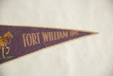 Purple felt flag's pointed tip with tan border showing slight material loss.