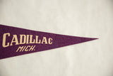 Vintage Cadillac Michigan felt pennant with cream 'CADILLAC MICH.' lettering on deep purple.