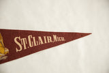 Angled view of the St. Clair, Mich. text on the vintage maroon felt pennant.
