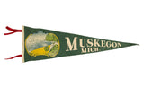 Vintage dark green felt Muskegon Michigan pennant with 1940s seascape, sailboat, and trees. 8x26.