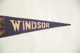 Aged cream lettering on the textured dark blue felt of the vintage Windsor pennant.