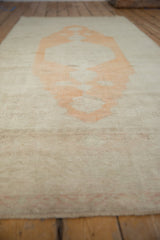 A low perspective showing the vintage runner's texture and even wear to the knot heads.