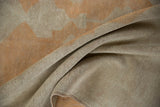 A soft fold in the vintage Oushak runner reveals its even, low-pile texture.