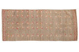 Vintage Distressed Oushak runner with faded raspberry, orange, ivory floral blossoms on a muted tan field. 2'4