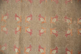 Hand-knotted distressed Oushak rug with raspberry and ivory floral motifs, showing even wear.