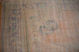 Vintage distressed Oushak rug with low pile, apricot, faded blue, mint floral border.