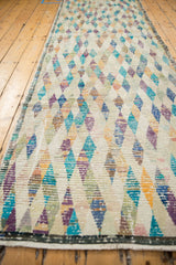 Distressed Tulu runner showing worn diamond pattern, vibrant colors, and intact side selvage.