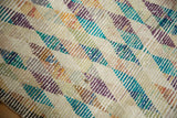 Distressed diamond lattice pattern on the vintage Tulu runner, featuring ivory, turquoise, aubergine, seafoam.