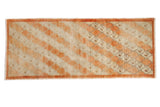 Vintage distressed Oushak runner with a layered diagonal trellis pattern in pale rust and antique ivory.