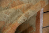 Evenly worn, low pile of a distressed Turkish Oushak runner showing the sturdy side selvage.