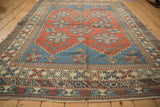 Distressed Melas carpet detail: repeating geometric medallions, starbursts, and pawn border.
