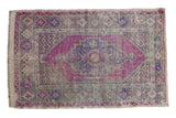 Distressed Vintage Oushak rug with stepped medallion, floral motifs, in aubergine, blue, and seafoam green.