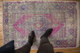 Distressed vintage Oushak rug showing a fuchsia field, muted blue-green patterns, and visible foundation wear.