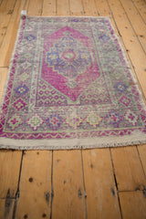 Distressed Oushak rug corner, magenta germinating seed spandrel, stepped geometric border, seafoam.