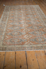 Distressed vintage Oushak rug section with faded dusty rust, silver, and ivory geometric motifs.
