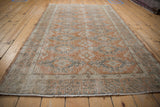 Distressed vintage Oushak rug with geometric border in dusty rust and oxidized silver.