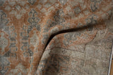 Distressed texture revealing dusty rust, oxidized silver, and ivory geometric motifs on an Oushak rug.