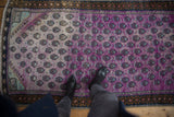 Distressed Oushak runner with aubergine and mint germinating plants, distinct geometric borders.